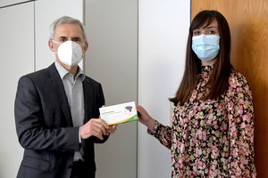 Geschäftsführer Reinhold Mühlbeyer und Frau Valeska Haase bei der Übergabe eines Selbsttests auf Covid-19  